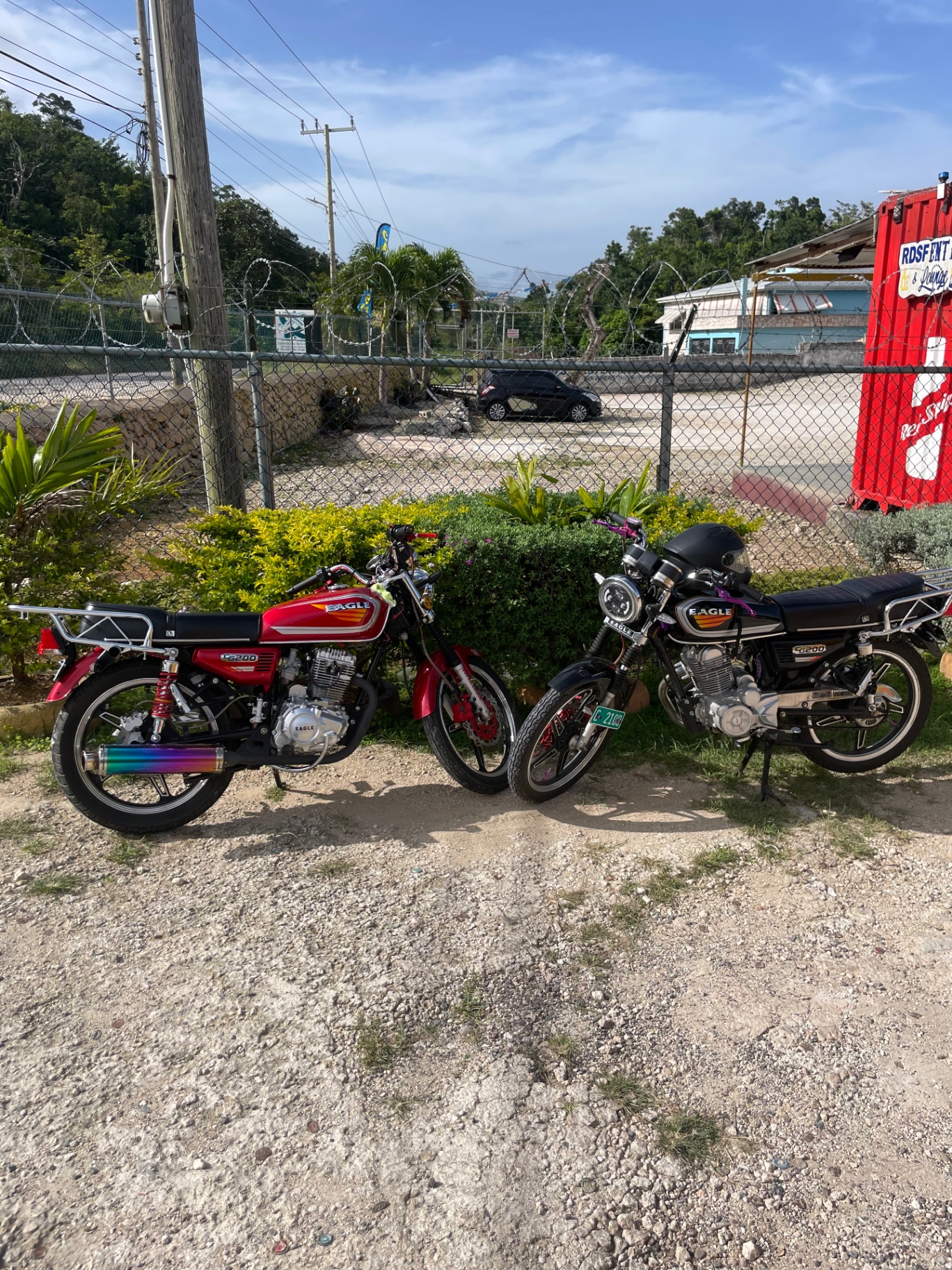 Two Look to Luke delivery motorcycles parked in Manchester, Jamaica
